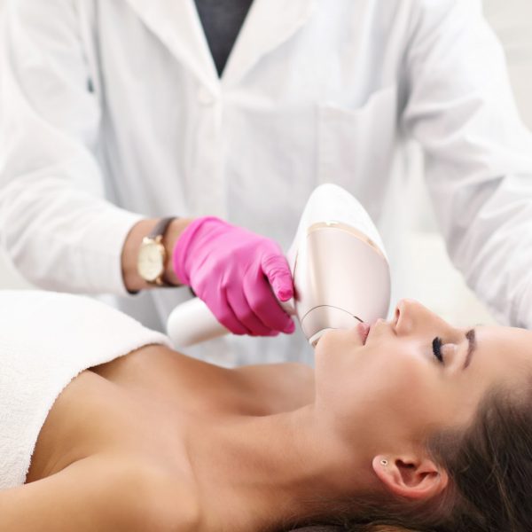 Picture of adult woman having laser hair removal in professional beauty salon